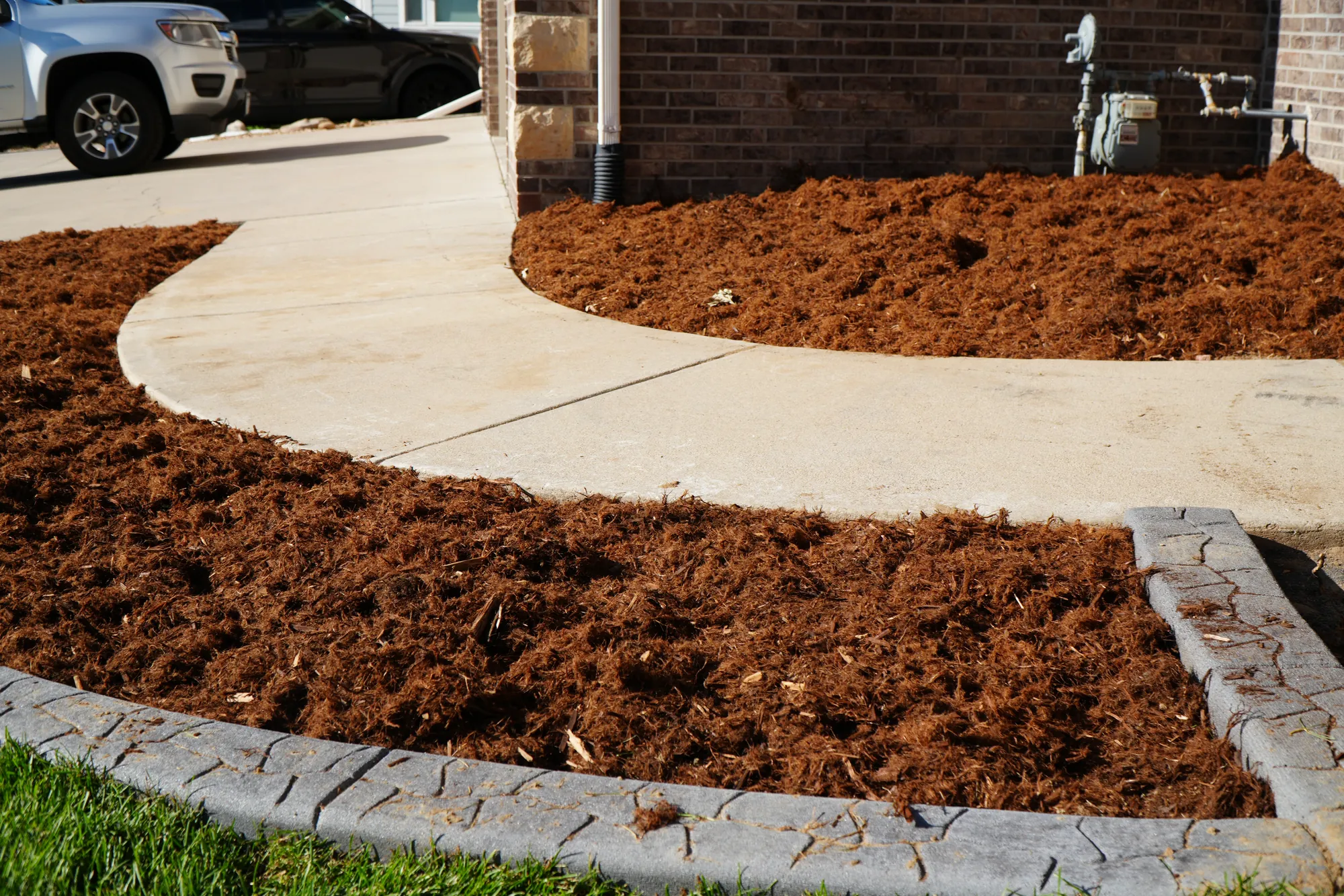 Mulch Beds: fresh mulch beds with curbing that follows the curve of the front walkway
