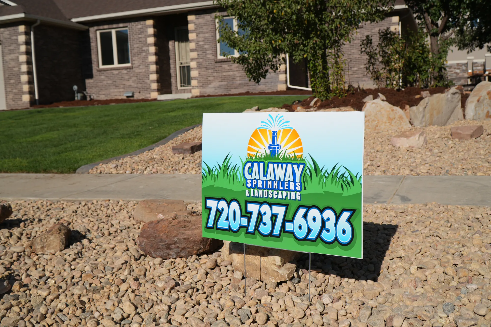 Front Yard: finished rock landscaping with a Calaway Sprinklers yard sign